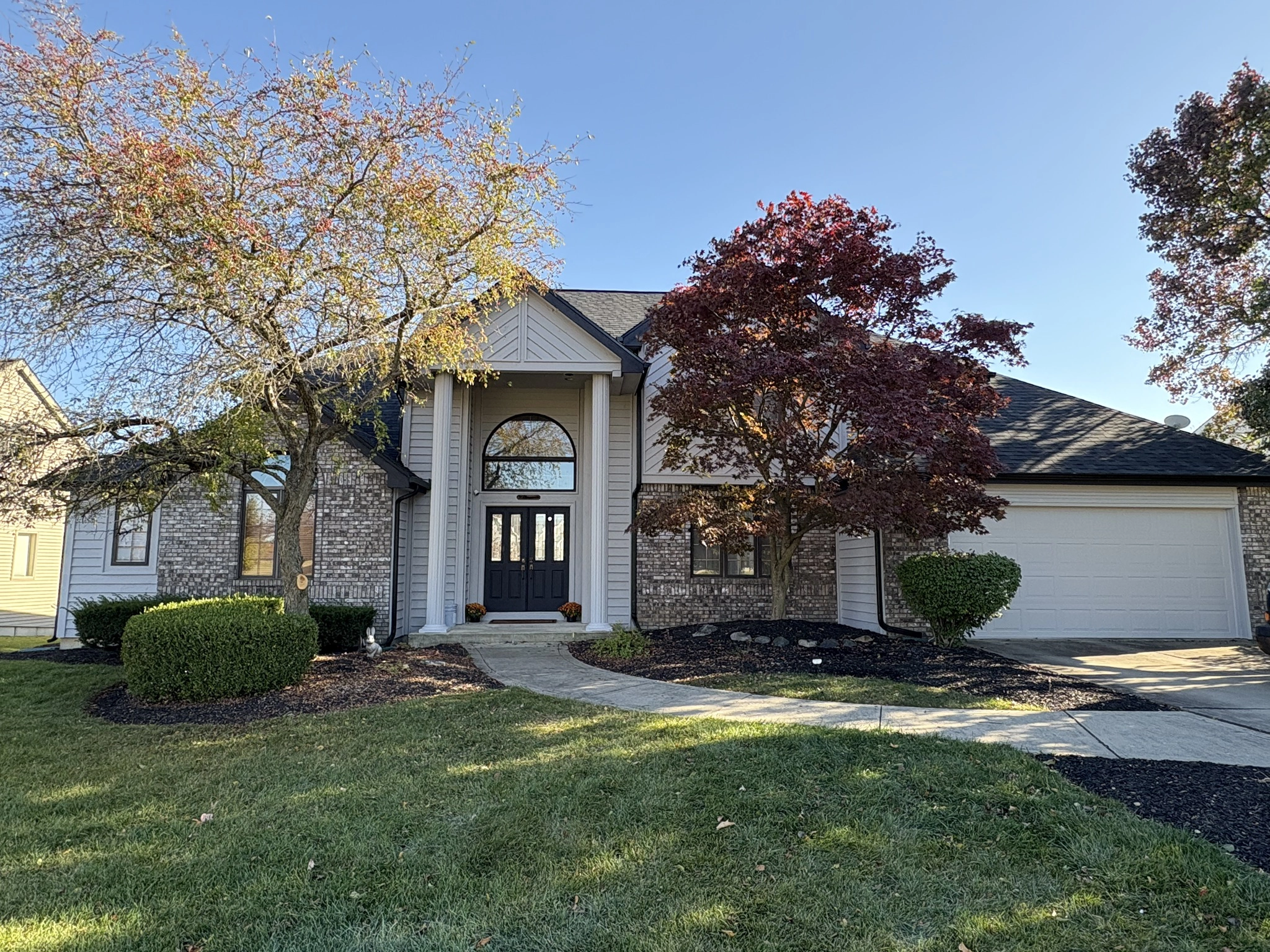 Home with dark shingle roof