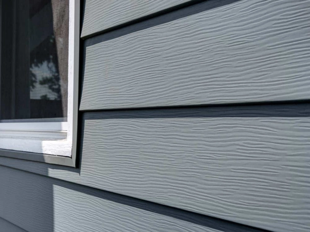 Aluminum siding close-up with window trim