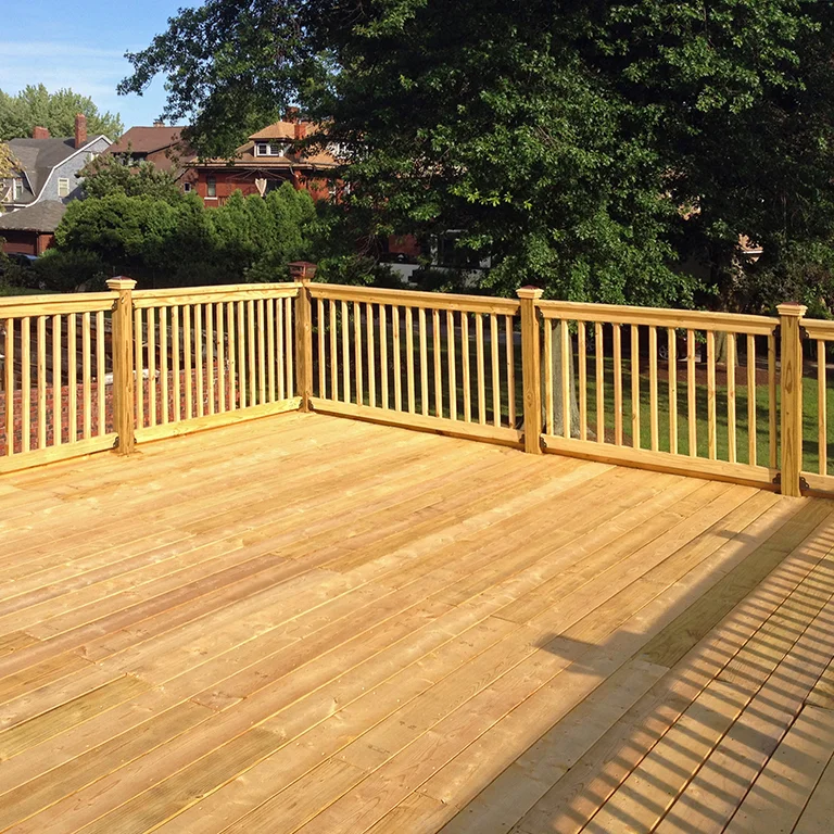 Pressure treated wood deck with railing